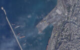 This satellite photograph taken by Planet Labs PBC show the smoldering wreckage after an alleged Israeli strike on the port at Latakia, Syria,  Dec. 29, 2021 (Planet Labs PBC via AP)