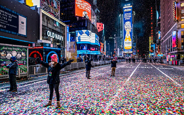 Jaclyn Bernstein of New York stands in confetti, among the few to observe the Times Square New Year's Eve ball drop early Friday, Jan. 1, 2021. (AP/Craig Ruttle) Jaclyn Bernstein of New York stands in confetti, among the few to observe the Times Square New Year's Eve ball drop early Friday, Jan. 1, 2021. (AP/Craig Ruttle)