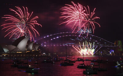 Fireworks explode over the Sydney Opera House and Harbor Bridge as New Year's Eve celebrations begin in Sydney, December 31, 2021. (Dean Lewins/AAP Image via AP)