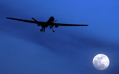 In this January 31, 2010 file photo, an unmanned US Predator drone flies over Kandahar Air Field, southern Afghanistan, on a moon-lit night. (AP Photo/Kirsty Wigglesworth, File)