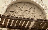 The mortar-covered frame of a synagogue's stained glass window is visible following renovations at the hospital of Bilohirsk in Crimea. (Crimea24 via JTA)
