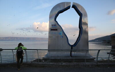 People visit a promenade in the city of Tiberias, next to the Sea of Galilee on January 30, 2020. (David Cohen/Flash90)