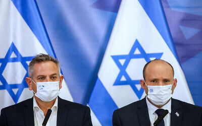 Illustrative: Prime Minister Naftali Bennett, right, and Health Minister Nitzan Horowitz hold a press conference at the HaKirya military base in Tel Aviv, November 26, 2021. (Moti Milrod) Illustrative: Prime Minister Naftali Bennett, right, and Health Minister Nitzan Horowitz hold a press conference at the HaKirya military base in Tel Aviv, November 26, 2021. (Moti Milrod)