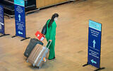 An arrival at Ben Gurion International Airport, on November 28, 2021, heads to a mandatory COVID test. (Avshalom Sassoni/Flash90)