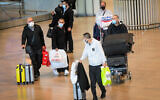 Arriving travelers walk to the COVID-19 testing area at Ben Gurion International Airport, on November 28, 2021. (Avshalom Sassoni/Flash90)