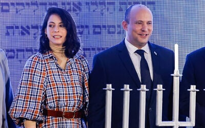 Prime Minister Naftali Bennett and his wife Gilat attend a Hanukkah ceremony in Jerusalem, on November 29, 2021.(Olivier Fitoussi/Flash90) Prime Minister Naftali Bennett and his wife Gilat attend a Hanukkah ceremony in Jerusalem, on November 29, 2021.(Olivier Fitoussi/Flash90)