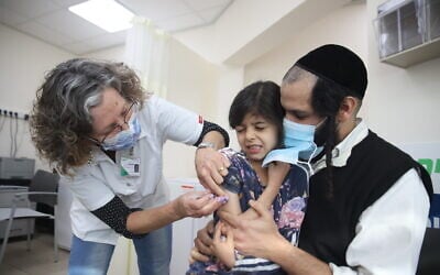 Children aged 5-11 receive their first dose of a COVID-19 vaccine, at Clallit vaccination center in Tzfat, on December 3, 2021. (David Cohen/Flash90) Children aged 5-11 receive their first dose of a COVID-19 vaccine, at Clallit vaccination center in Tzfat, on December 3, 2021. (David Cohen/Flash90)