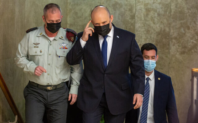 Israeli Prime Minister Naftali Bennett arrives for a cabinet meeting at the Prime Minister's Office in Jerusalem on December 5, 2021. (Emil Salman/POOL) Israeli Prime Minister Naftali Bennett arrives for a cabinet meeting at the Prime Minister's Office in Jerusalem on December 5, 2021. (Emil Salman/POOL)