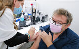 An Israeli receives a dose of the COVID vaccine n Katzrin, Golan Heights, on December 12, 2021. (Michael Giladi/Flash90)