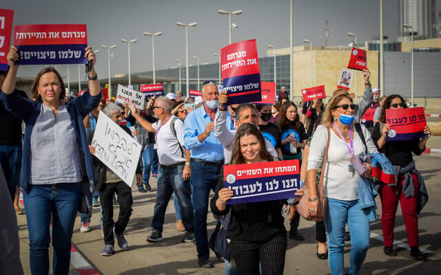 Workers from the tourism sector, calling for financial support from the Israeli government, protest outside Ben Gurion International Airport, on December 13, 2021. (Avshalom Sassoni/Flash90) Workers from the tourism sector, calling for financial support from the Israeli government, protest outside Ben Gurion International Airport, on December 13, 2021. (Avshalom Sassoni/Flash90)