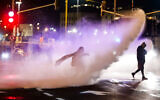 Police use a water cannon to disperse a group of protesters in Jerusalem, on Saturday, December 18, 2021. (Olivier Fitoussi/Flash90)