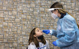 A COVID-19 rapid antigen test being carried out at a Magen David Adom testing center in Jerusalem, on December 22, 2021. (Olivier Fitoussi/Flash90)