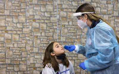 A COVID-19 rapid antigen test being carried out at a Magen David Adom testing center in Jerusalem, on December 22, 2021. (Olivier Fitoussi/Flash90)