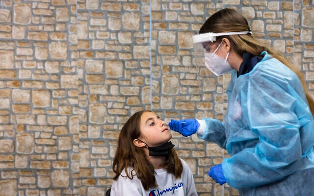 A COVID-19 rapid antigen test being carried out at a Magen David Adom testing center in Jerusalem, on December 22, 2021. (Olivier Fitoussi/Flash90) A COVID-19 rapid antigen test being carried out at a Magen David Adom testing center in Jerusalem, on December 22, 2021. (Olivier Fitoussi/Flash90)