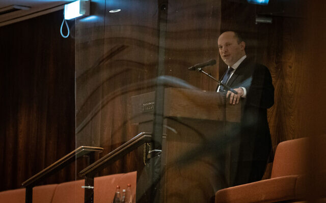 Prime Minister Naftali Bennett is seen in the isolation section during a Knesset plenum session on December 27, 2021. (Noam Revkin Fenton/Flash90) Prime Minister Naftali Bennett is seen in the isolation section during a Knesset plenum session on December 27, 2021. (Noam Revkin Fenton/Flash90)