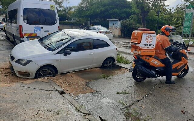 A car that fell into a sinkhole in Netanya on December 21, 2021. (United Hatzalah) A car that fell into a sinkhole in Netanya on December 21, 2021. (United Hatzalah)