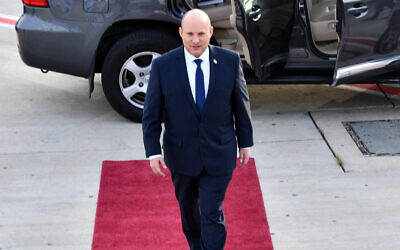 Prime Minister Naftali Bennett boards a plane at Ben Gurion Airport for the United Arab Emirates, on December 12, 2021. (Haim Zach/GPO)