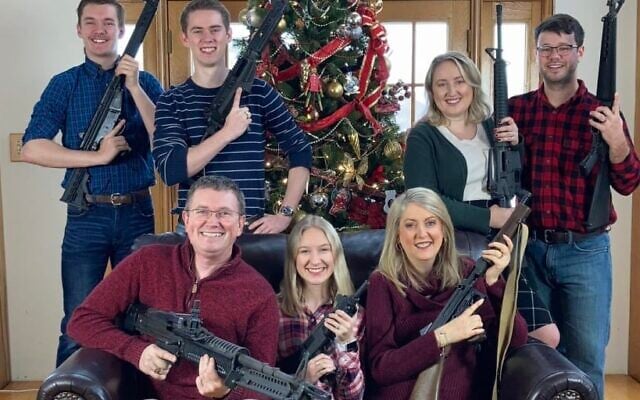 Congressman Thomas Massie poses with six members of his family holding guns with the words 'Merry Christmas! ps. Santa, please bring ammo' (Twitter) Congressman Thomas Massie poses with six members of his family holding guns with the words 'Merry Christmas! ps. Santa, please bring ammo' (Twitter)