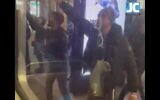 A man (R) appears to make a Nazi salute, in a video showing a group of people accosting Jews on a Chabad bus as they celebrated Hanukkah in London, November 28, 2021. (Screen capture: Twitter)