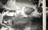 Security camera footage shows two suspects fleeing after firebombing a car owned by a Jewish resident of East Jerusalem's Sheikh Jarrah neighborhood, December 12, 2021. (Screen capture: Twitter)
