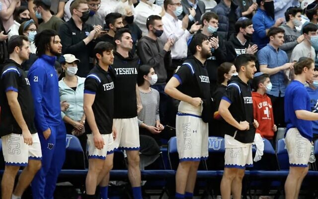 Players on Yeshiva University's basketball team are seen at the end of the game against Illinois Wesleyan University on December 30, 2021. The Maccabees lost, ending the team's 50-game winning streak. (Screen capture: YouTube) Players on Yeshiva University's basketball team are seen at the end of the game against Illinois Wesleyan University on December 30, 2021. The Maccabees lost, ending the team's 50-game winning streak. (Screen capture: YouTube)