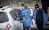 Health care workers test people for COVID-19 in Jerusalem on December 21, 2021. (Yonatan Sindel/Flash90)