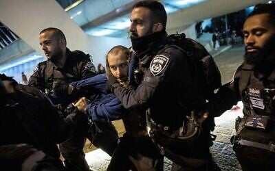 Police clash with far-right activists protesting the death of Ahuvia Sandak in Jerusalem on December 11, 2021. (Yonatan Sindel/Flash90) Police clash with far-right activists protesting the death of Ahuvia Sandak in Jerusalem on December 11, 2021. (Yonatan Sindel/Flash90)