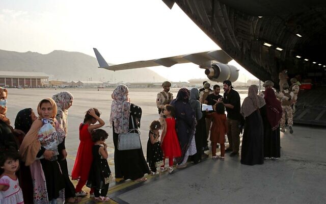 Afghans board a Qatari transport plane to leave the country in Kabul, Afghanistan, August, 18, 2021. (Qatar Government Communications Office via AP) Afghans board a Qatari transport plane to leave the country in Kabul, Afghanistan, August, 18, 2021. (Qatar Government Communications Office via AP)