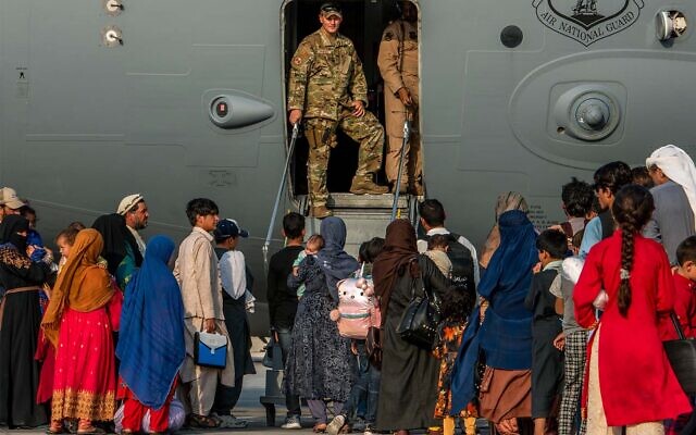 Afghan refugees prepare to board a plane at Al Udeid Air Base, Qatar, August 22, 2021. (Airman 1st Class Kylie Barrow/U.S. Air Force via AP) Afghan refugees prepare to board a plane at Al Udeid Air Base, Qatar, August 22, 2021. (Airman 1st Class Kylie Barrow/U.S. Air Force via AP)