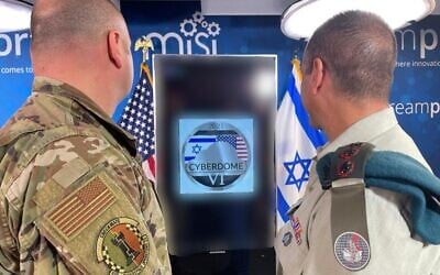 In this handout image published by the Israel Defense Forces on December 18, 2021, a United States Cyber Command officer and an Israeli Joint Cyber Defense Division officer are seen at a US Cyber ​​Command facility in the United States. (Israel Defense Forces)