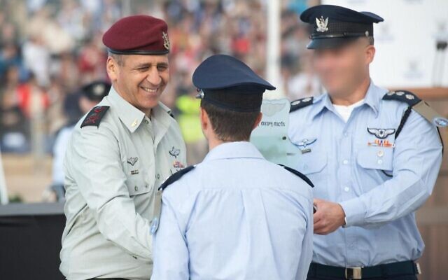 IDF chief Aviv Kohavi shakes hands with a graduates during a ceremony marking the end of the Israeli Air Force's pilot course, at the Hatzerim airbase in southern Israel, on December 22, 2021. (Israel Defense Forces) IDF chief Aviv Kohavi shakes hands with a graduates during a ceremony marking the end of the Israeli Air Force's pilot course, at the Hatzerim airbase in southern Israel, on December 22, 2021. (Israel Defense Forces)