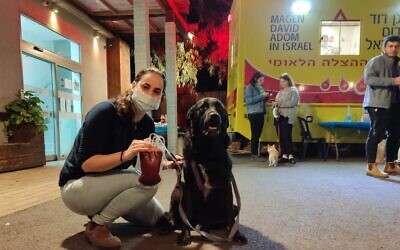 A woman and her dog, after both giving blood, at a human-and-canine donation day. (Moran Baranes)