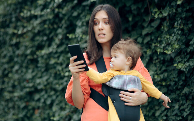 Stressed mother holding smartphone (iStock) Stressed mother holding smartphone (iStock)