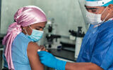 A woman with cancer receives a coronavirus vaccine (Hector Pertuz via iStock by Getty Images)