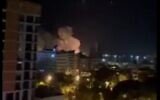 Smoke rises from an alleged Israeli missile strike on the Syrian port of Latakia on December 7, 2021 (Screencapture/Twitter)
