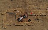 Members of a French-Iraqi archaeological expedition work on a dig at the site of the Sumerian city-state of Larsa, in the Qatiaah area of Iraq's southern province of Dhi Qar near the city of Nasiriyah, on November 23, 2021. (Asaad Niazi/AFP)
