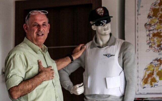 Dany Tirza, stands next to a dummy as he speaks at his office in the West bank settlement of Kfar Adumim, on December 14, 2021. (Ahmad Gharbali/ AFP) Dany Tirza, stands next to a dummy as he speaks at his office in the West bank settlement of Kfar Adumim, on December 14, 2021. (Ahmad Gharbali/ AFP)