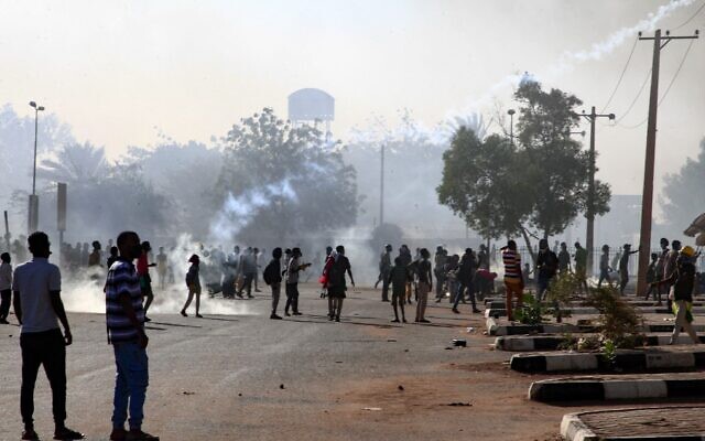 Sudanese protesters gather amid tear gas fired by security forces during a demonstration against the October 25 coup, in the capital Khartoum, on January 2, 2022. (AFP) Sudanese protesters gather amid tear gas fired by security forces during a demonstration against the October 25 coup, in the capital Khartoum, on January 2, 2022. (AFP)