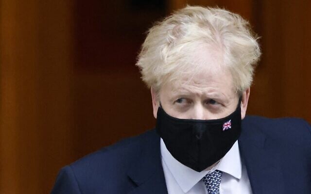 Britain's Prime Minister Boris Johnson, wearing a face covering to help mitigate the spread of COVID-19, leaves from 10 Downing Street in central London on January 12, 2022.(Tolga Akmen/AFP) Britain's Prime Minister Boris Johnson, wearing a face covering to help mitigate the spread of COVID-19, leaves from 10 Downing Street in central London on January 12, 2022.(Tolga Akmen/AFP)