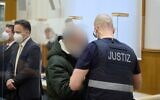 Former Syrian intelligence officer Anwar Raslan (C) arrives in the courtroom at a courthouse in Koblenz, western Germany, on January 13, 2022, on the last day of his trial where he was sentenced to life in jail for crimes against humanity in the first global trial over state-sponsored torture in Syria. (Photo by Thomas Frey / POOL / AFP)