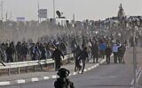 Bedouin protesters and Israeli forces clash during a protest in the southern Israeli village of Sawe al-Atrash in the Negev Desert against a forestation project by the Jewish National Fund (JNF), on January 13, 2022. (Menahem KAHANA / AFP)