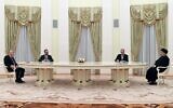 Russian President Vladimir Putin (left) speaks with Iranian President Ebrahim Raisi (right) during their meeting in Moscow, on January 19, 2022. (Pavel Bednyakov/Sputnik/AFP)