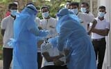 Health workers collect a swab sample from a man to test for the Covid-19 coronavirus in Colombo, Sri Lanka, on January 20, 2022. (AFP)