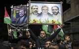 Palestinian Islamic Jihad supporters lift placards as they demonstrate in Gaza city on January 22, 2022, to denounce the war in Yemen. (Mahmud HAMS / AFP)