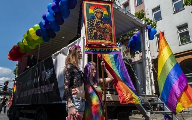 This file photo taken on June 26, 2021 shows demonstrators taking part in an LGBTQ pride march and displaying a Gay Church Berlin banner in Berlin. (John MACDOUGALL / AFP) This file photo taken on June 26, 2021 shows demonstrators taking part in an LGBTQ pride march and displaying a Gay Church Berlin banner in Berlin. (John MACDOUGALL / AFP)