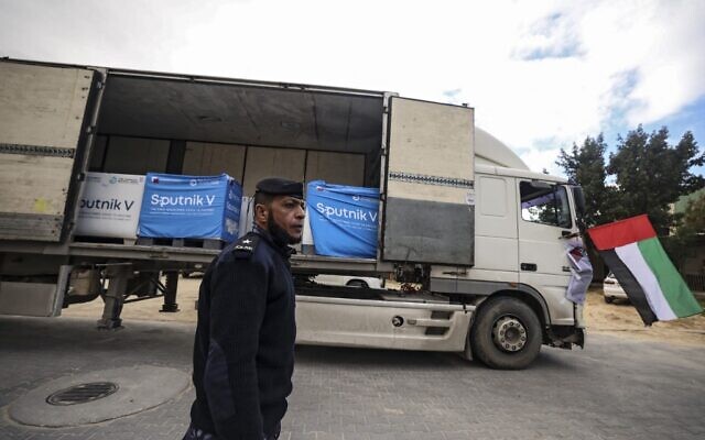 A Palestinian security officer stands next to a truck carrying Sputnik V vaccines, donated by the United Arab Emirates, at a cold storage warehouse in Gaza City on January 26, 2022. (Mahmud HAMS / AFP) A Palestinian security officer stands next to a truck carrying Sputnik V vaccines, donated by the United Arab Emirates, at a cold storage warehouse in Gaza City on January 26, 2022. (Mahmud HAMS / AFP)