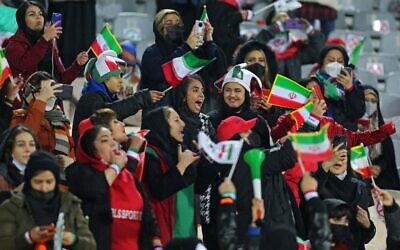 Female supporters of Iran's national soccer team cheer during the 2022 Qatar World Cup Asian Qualifiers match between Iran and Iraq, at the Azadi Sports Complex in the capital Tehran, on January 27, 2022. (Atta Kenare/AFP)