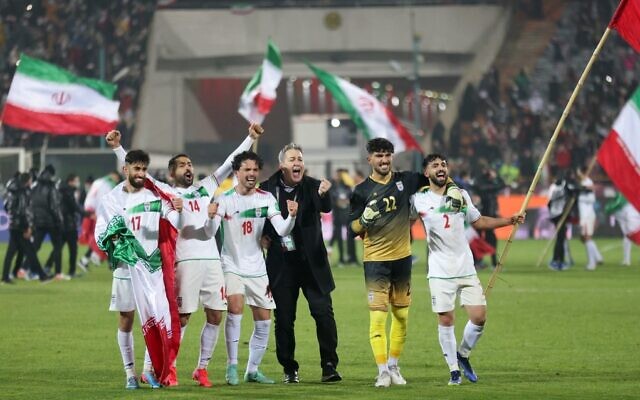 Players on Iran's national soccer team celebrate with fans after qualifying for the 2022 Qatar World Cup, after their win against Iraq in the Asian Qualifiers soccer match at the Azadi Sports Complex in the capital Tehran, on January 27, 2022. (Atta Kenare/AFP) Players on Iran's national soccer team celebrate with fans after qualifying for the 2022 Qatar World Cup, after their win against Iraq in the Asian Qualifiers soccer match at the Azadi Sports Complex in the capital Tehran, on January 27, 2022. (Atta Kenare/AFP)