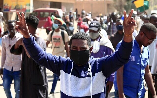 A Sudanese demonstrator flashes the victory sign as he takes part in a rally to protest against last year's military coup, in the capital Khartoum, on January 30, 2022. (AFP) A Sudanese demonstrator flashes the victory sign as he takes part in a rally to protest against last year's military coup, in the capital Khartoum, on January 30, 2022. (AFP)