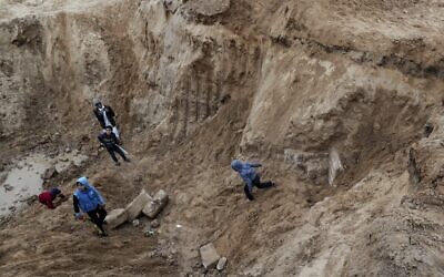 Palestinian boys play in an ancient cemetery reportedly dating back to the Roman-era which was unearthed during construction work in Gaza City on January 31, 2022. (Mahmud HAMS / AFP)